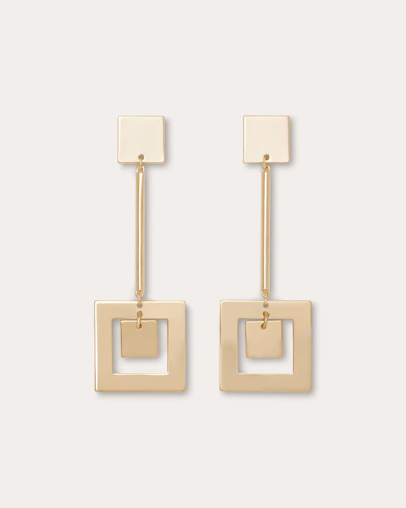Pair of gold square earrings on a light beige background